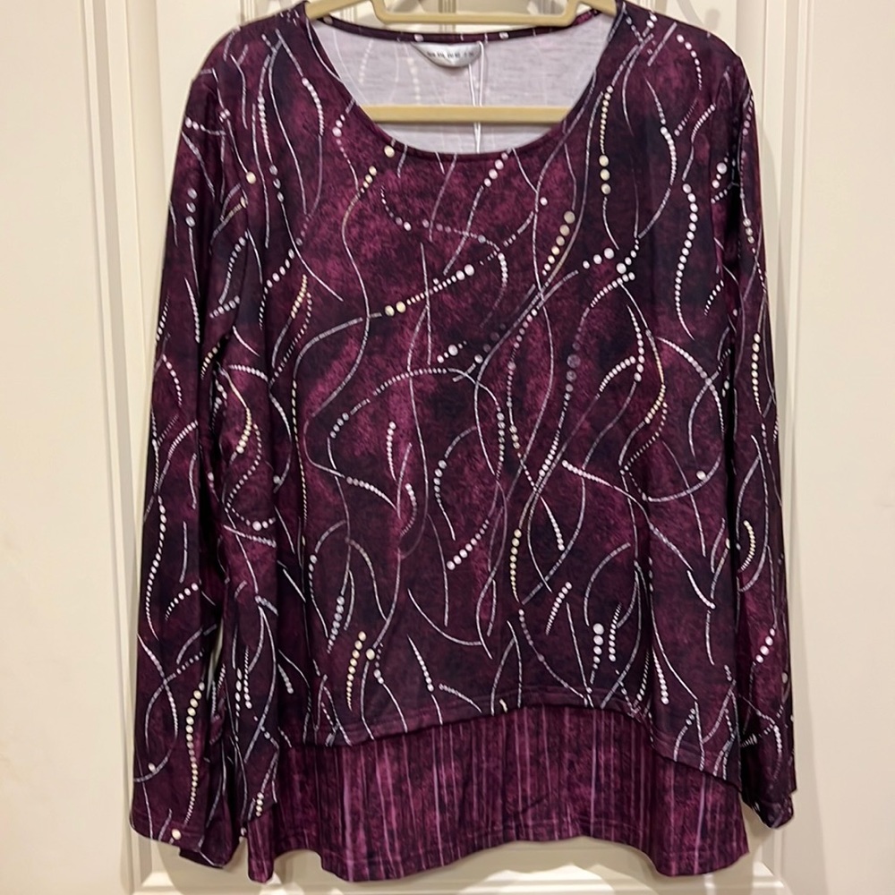 Shirt is Plum and purple colors with white accents